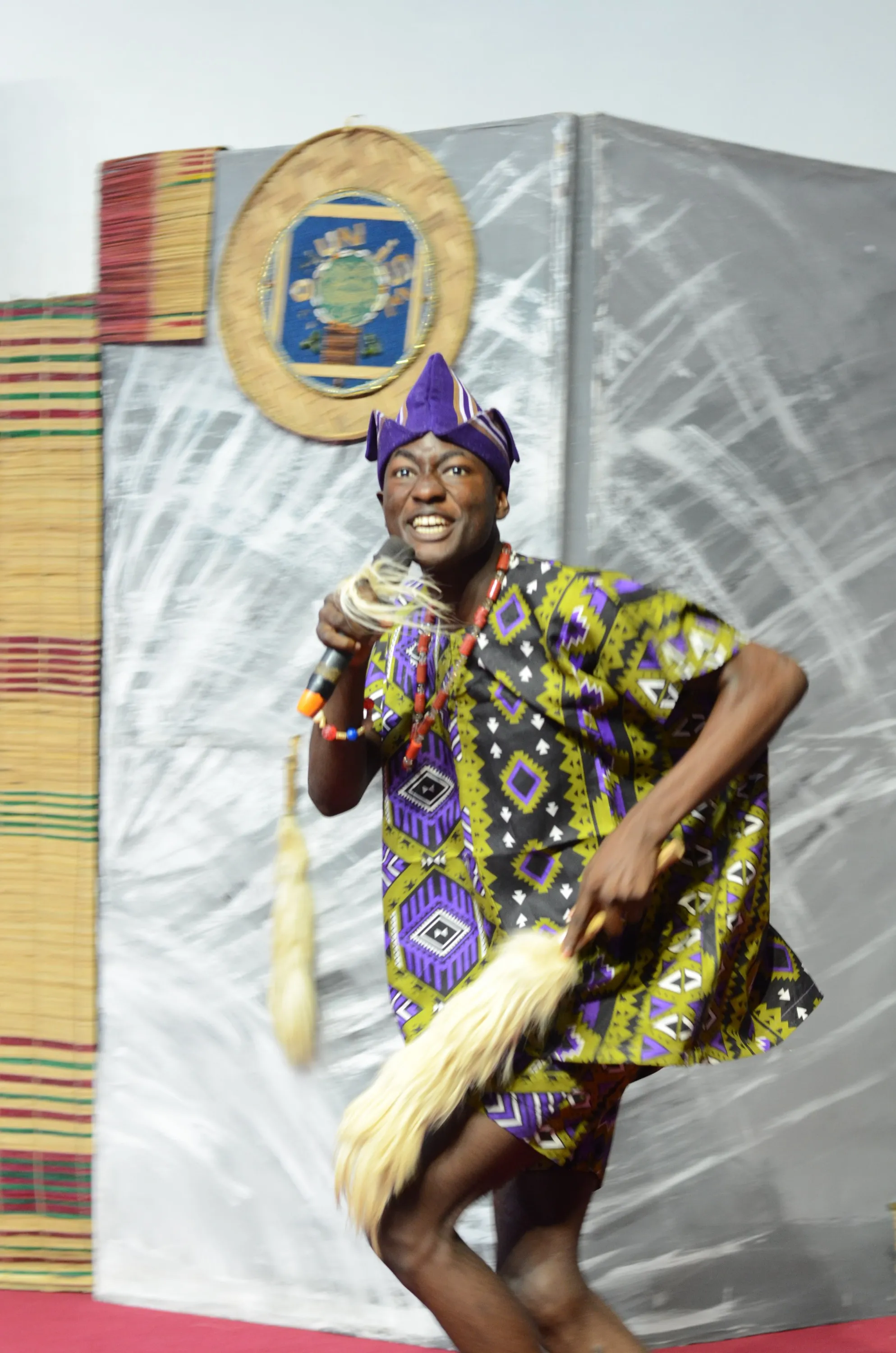 A young performer with a horsetail fly-whisk