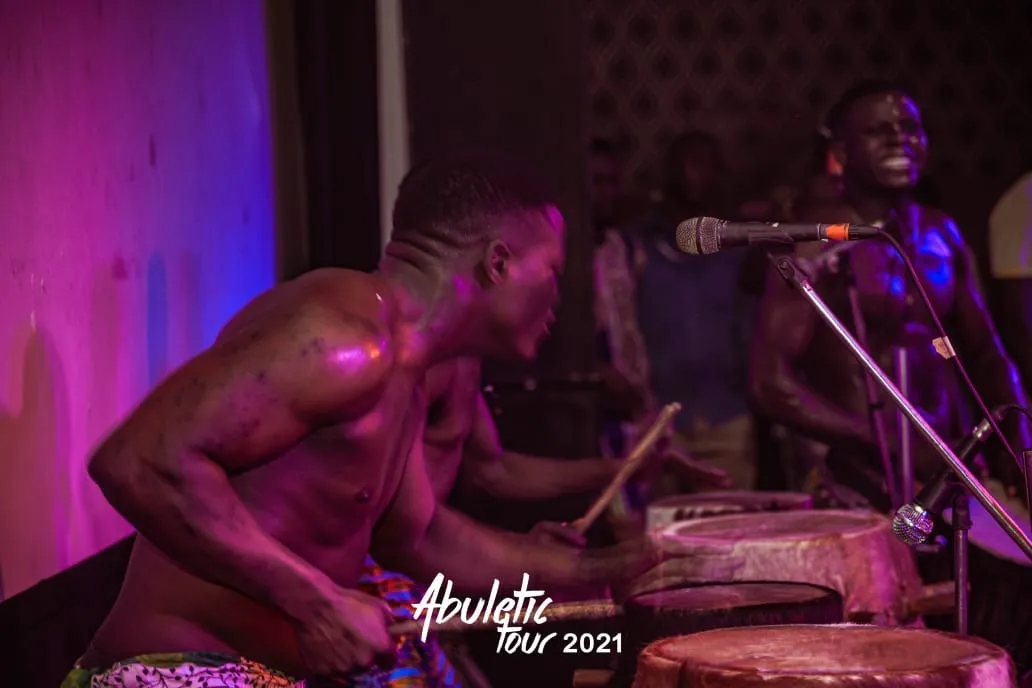 A drummer in magenta light