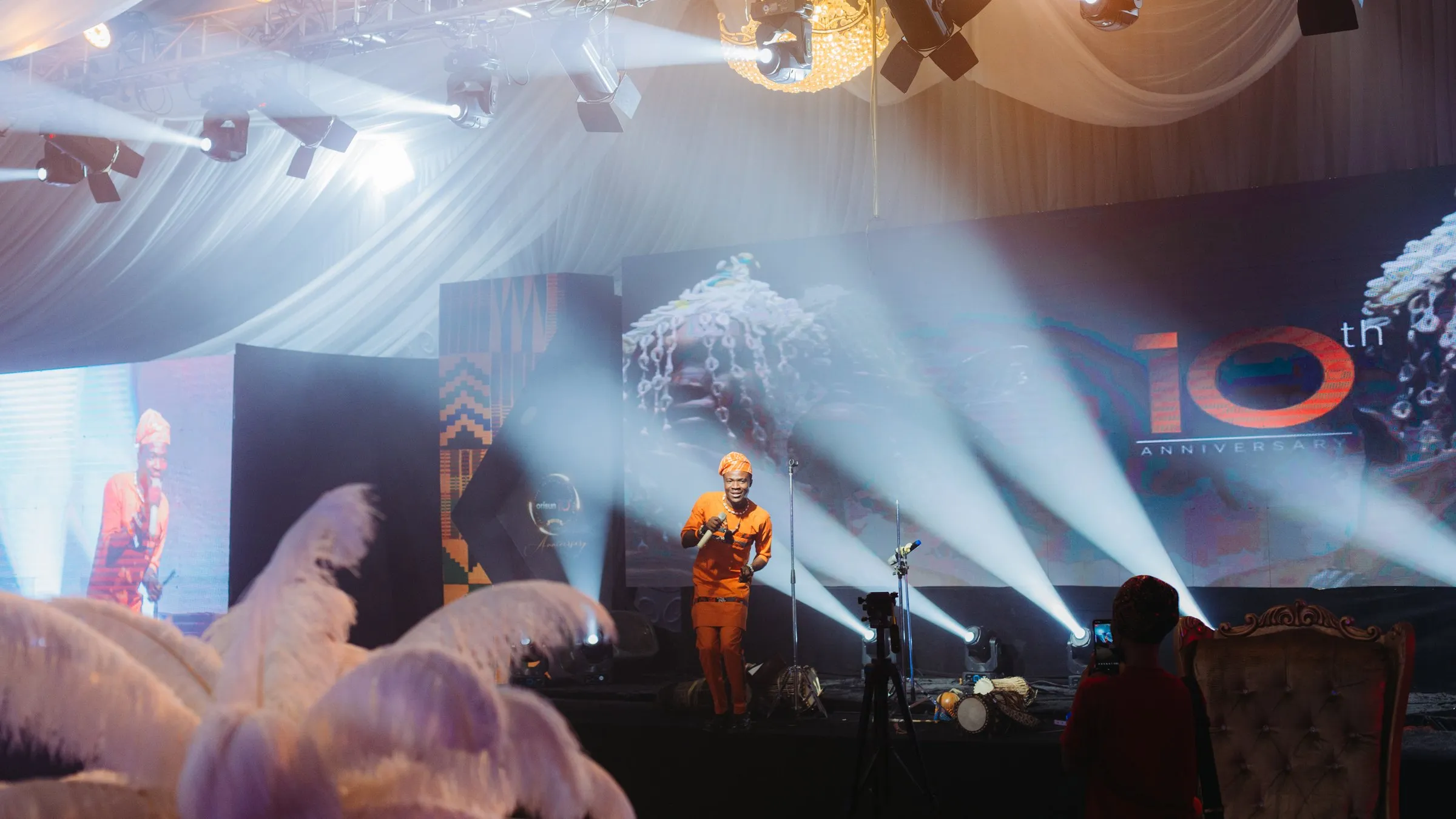 The marquee: draped white, feathers and light