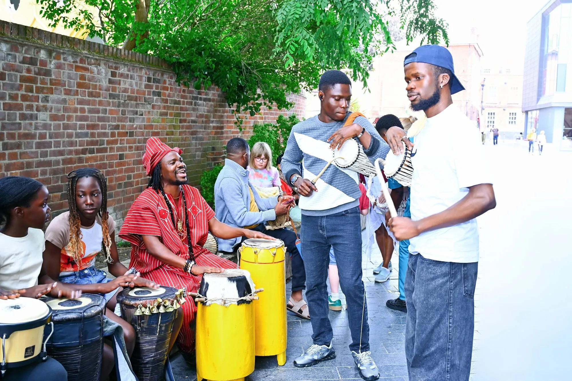 Drummers with the Abuletic King by the garden wall